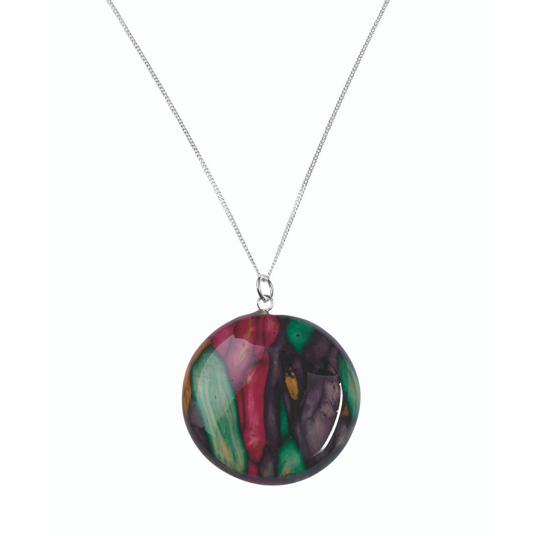 A multicolored circular Heathergem pendant on a sterling silver necklace chain.