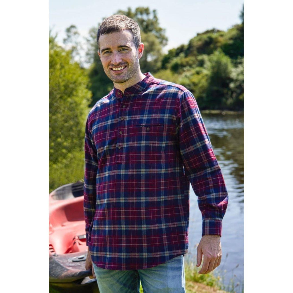 a man wearing a maroon and navy plaid grandfather shirt and jeans