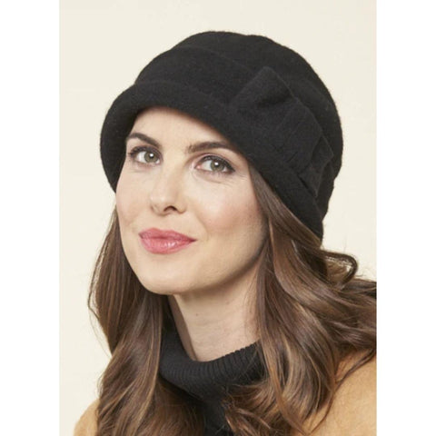 a brunette model wearing a black, close fitting cloche with band and bow